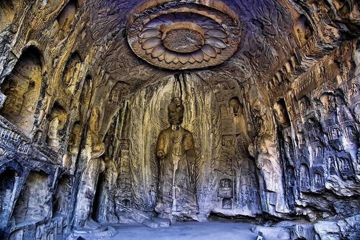 a cave with a statue in the wall