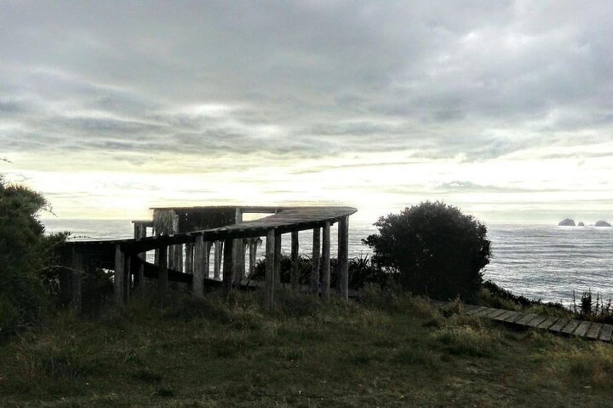 a building on a hill next to the ocean