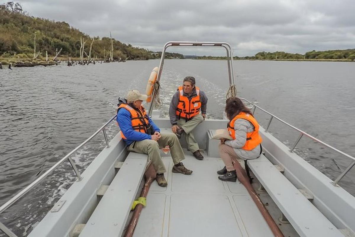 three people sitting on a boat in the water