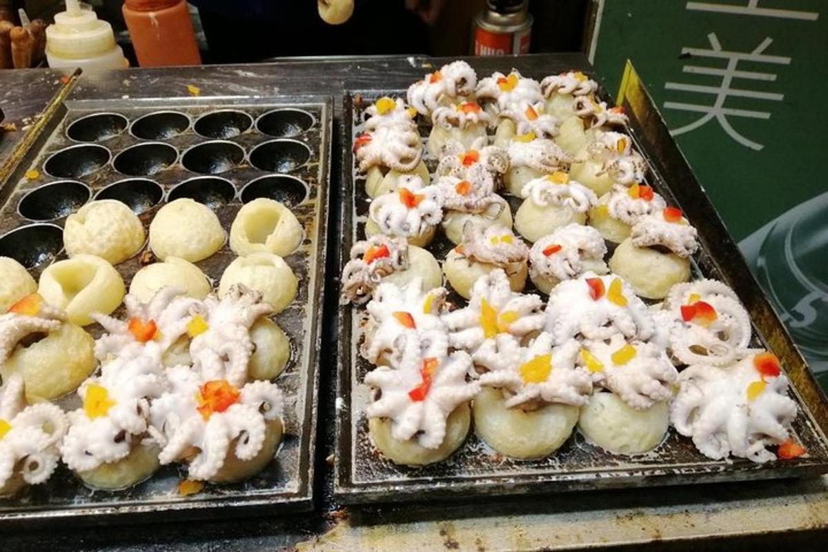 two trays of food with white food on top