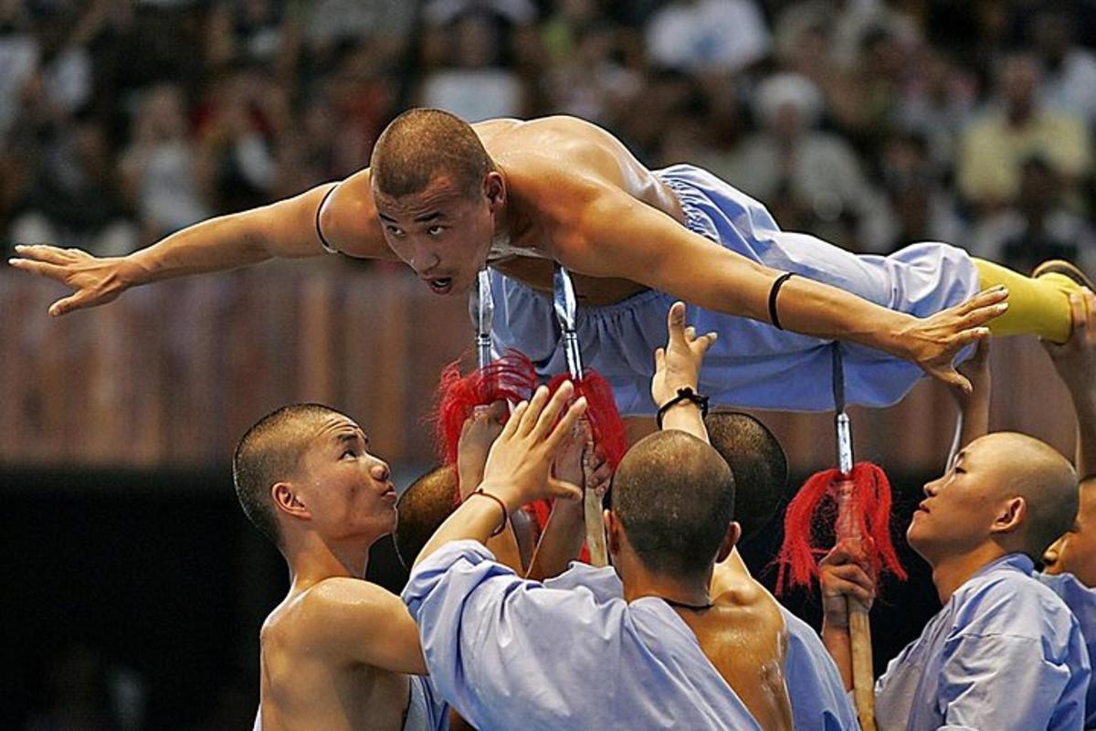 a man standing on top of a group of people