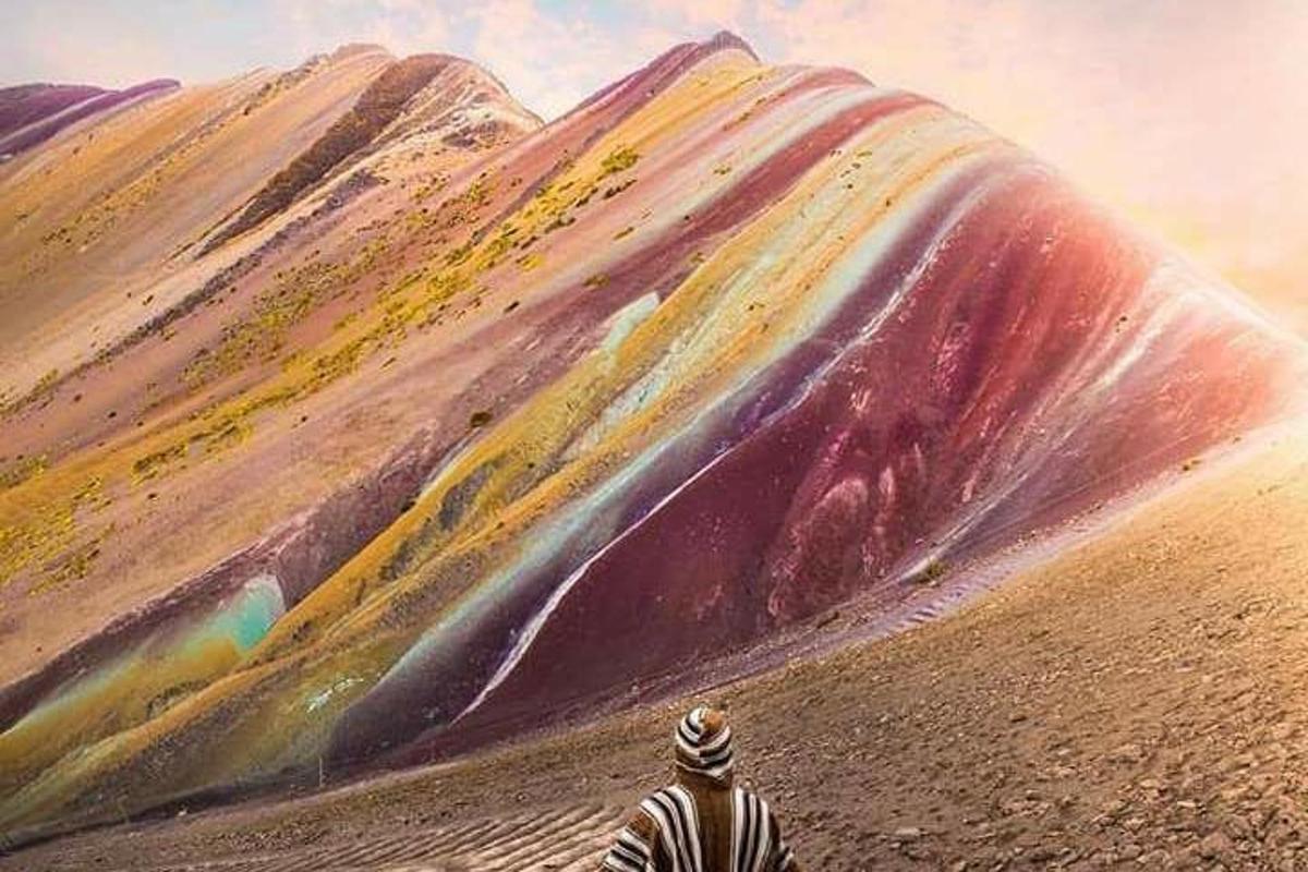 a man is standing in front of a mountain