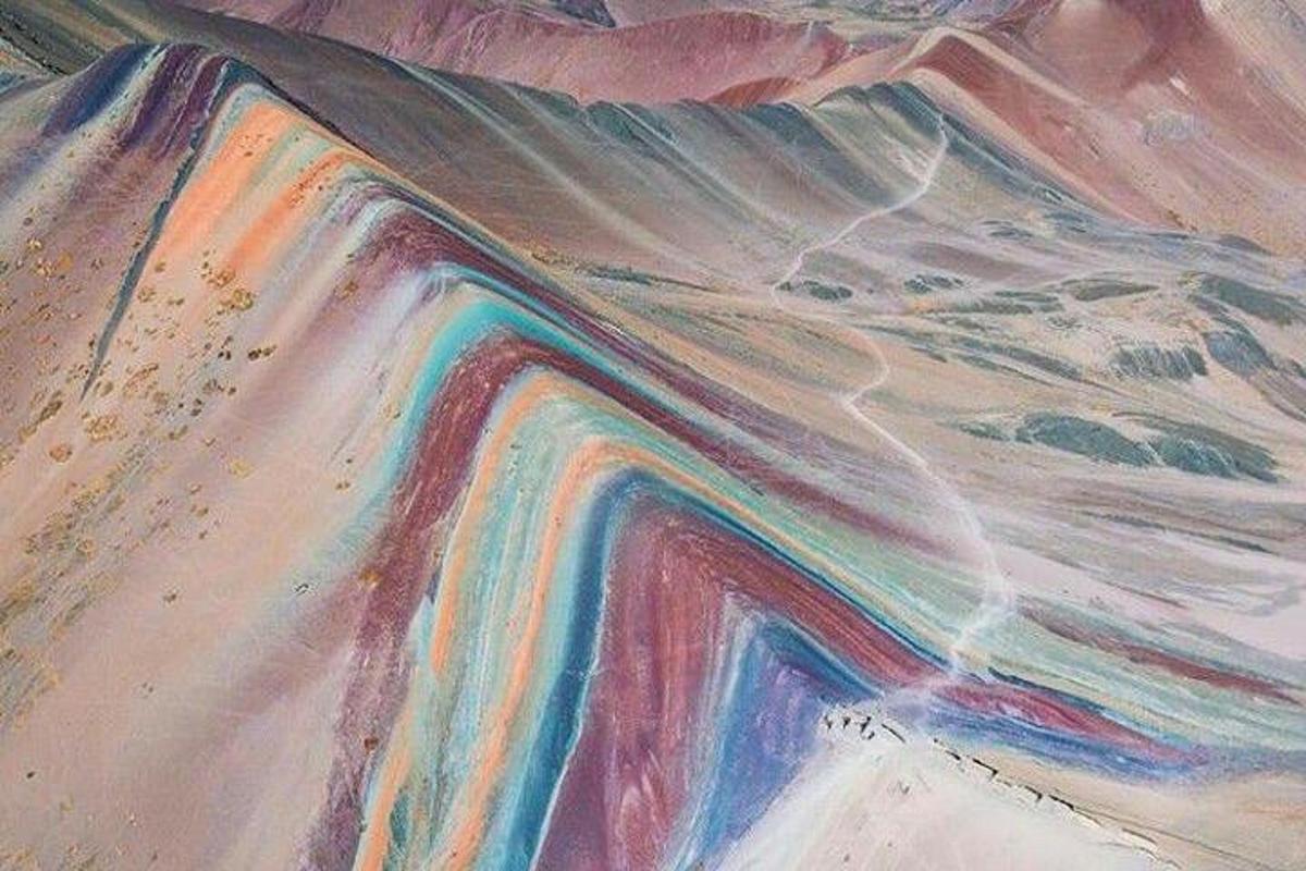 a painting of a desert with rainbow colors