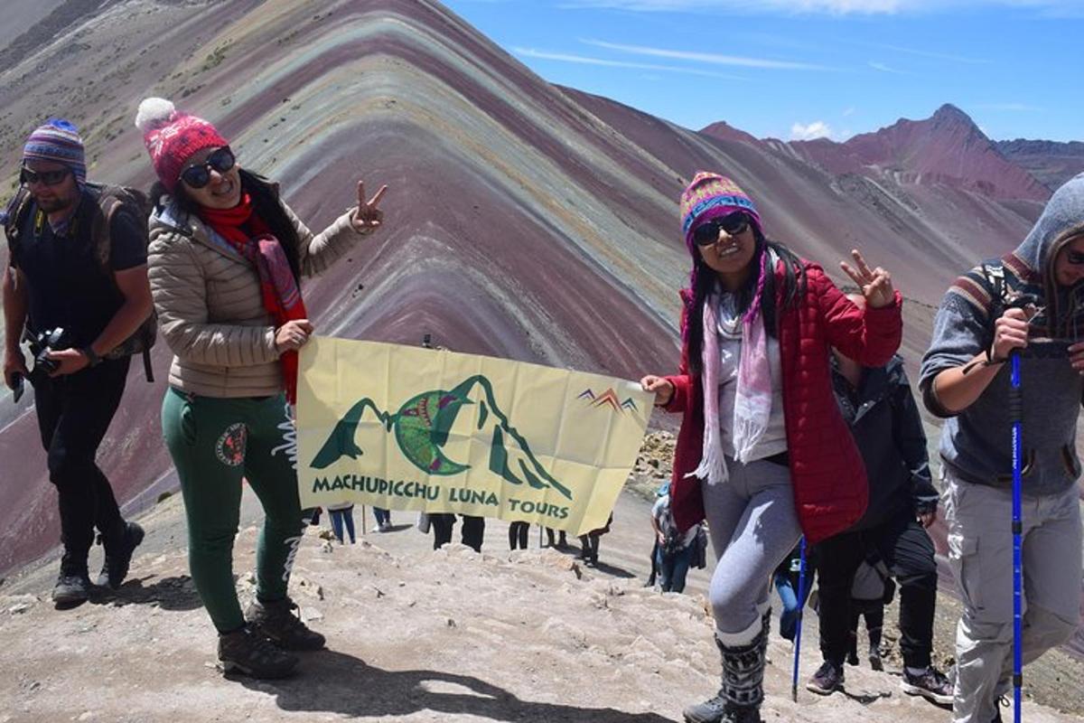 a group of people standing on top of a mountain