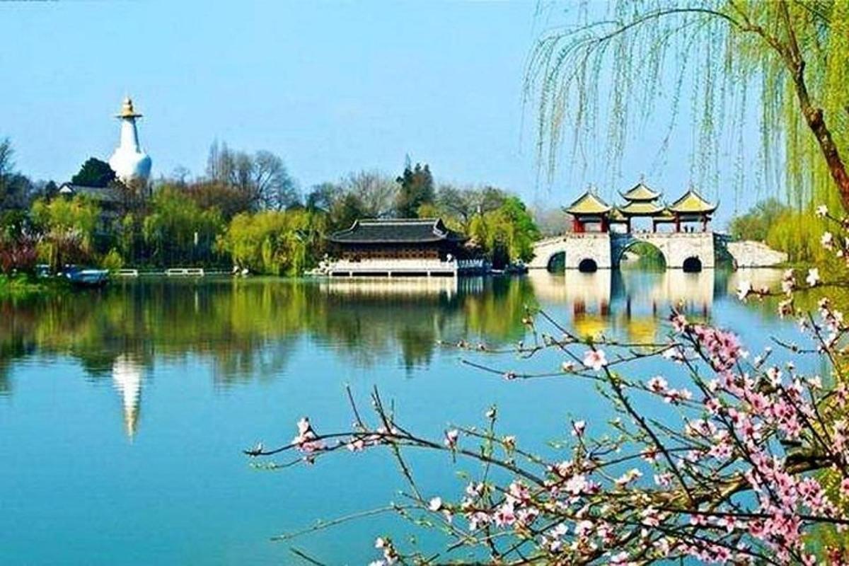 a lake with a building and a church and a cross