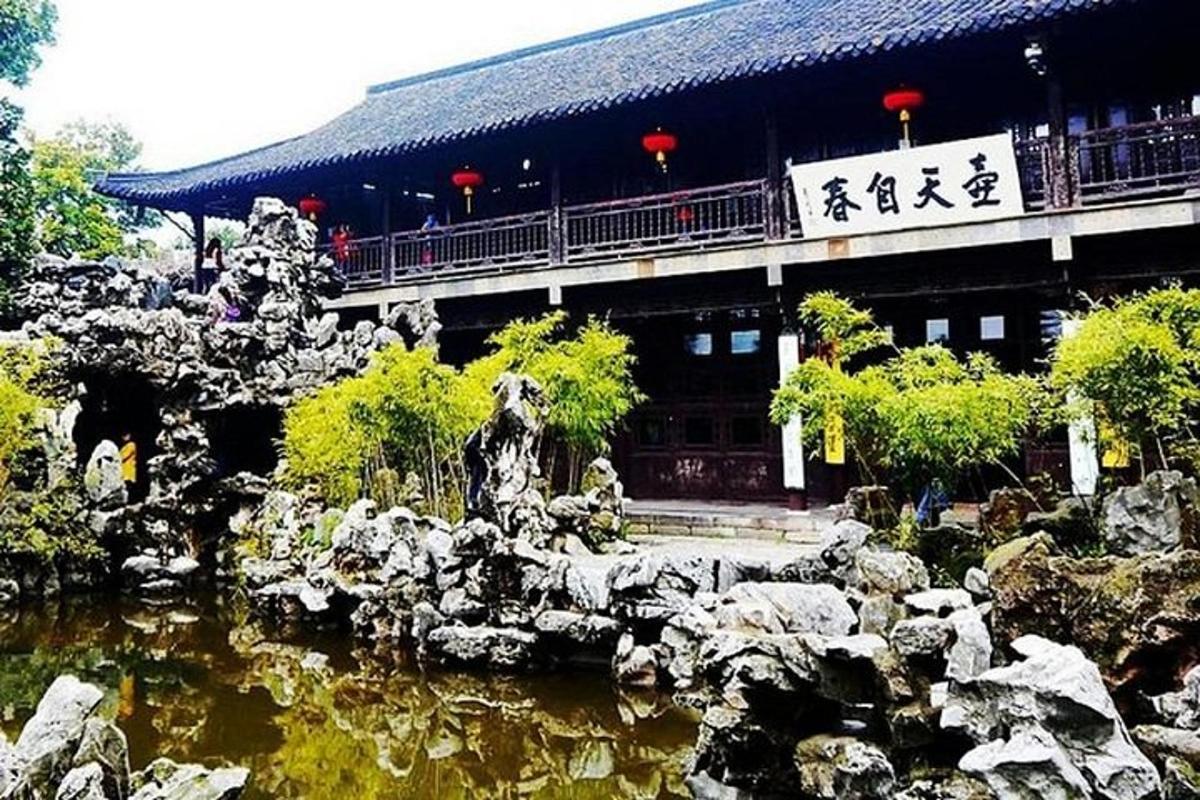 a building with a fountain in the middle of a pond