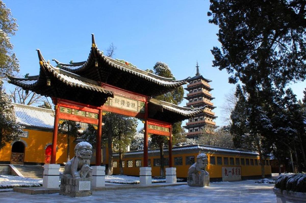 a temple with two statues in front of a building