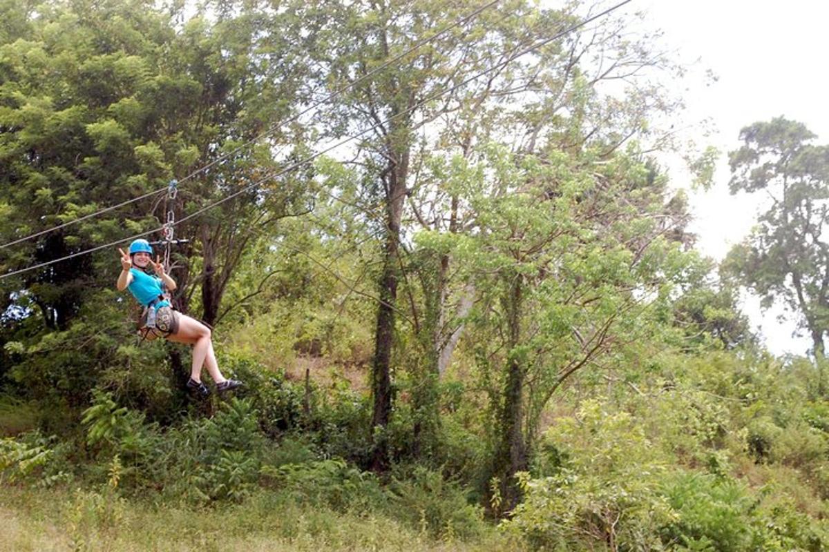 a woman on a zip line in the forest