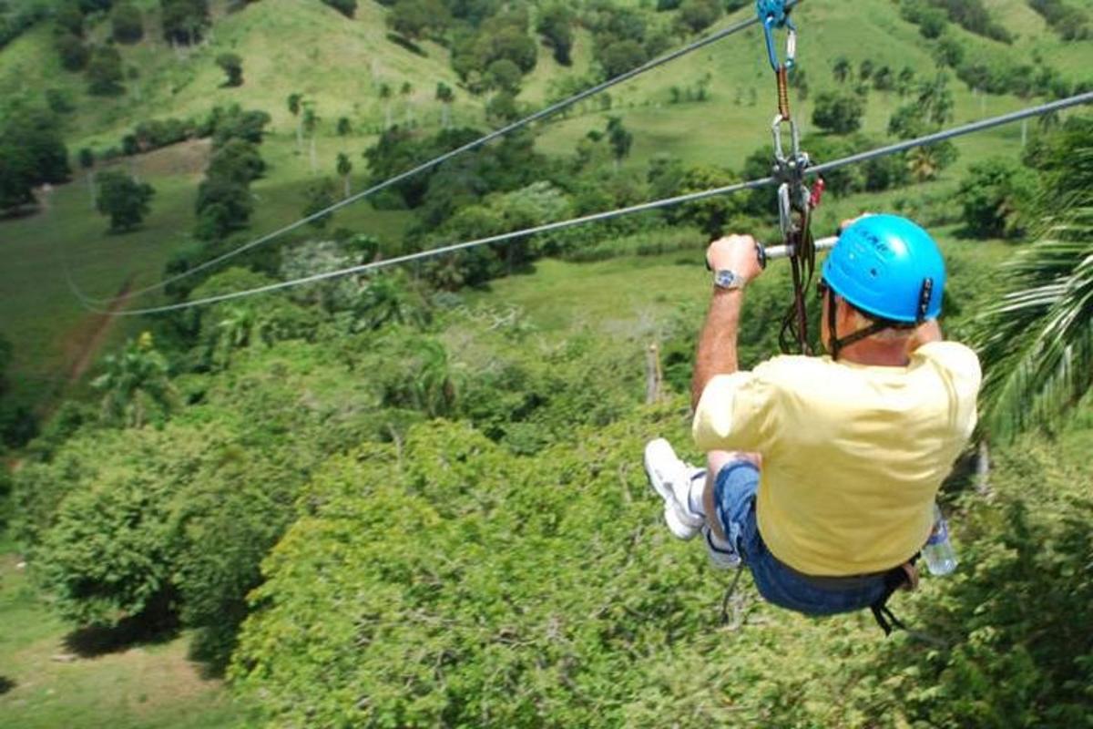 a man is hanging on a zip line