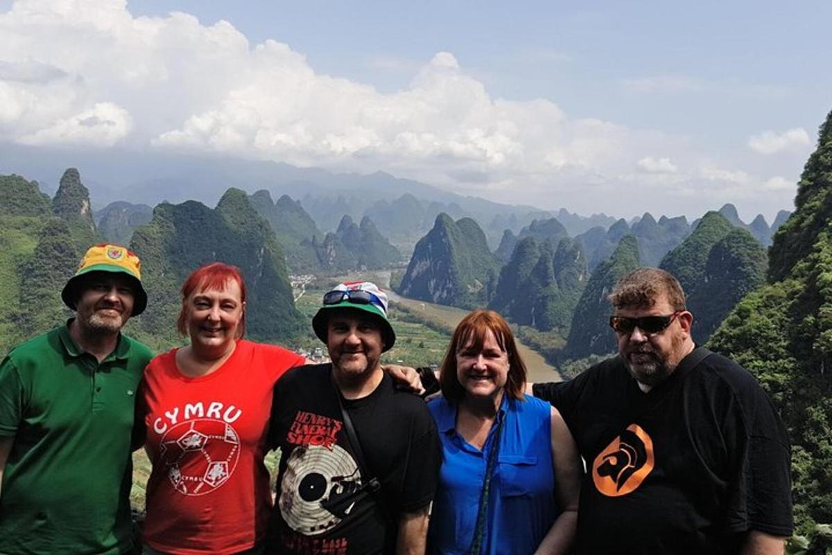 a group of people standing on top of a mountain