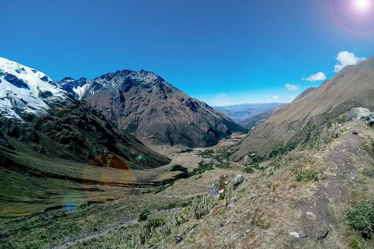 a view of a mountain range with snow capped mountains