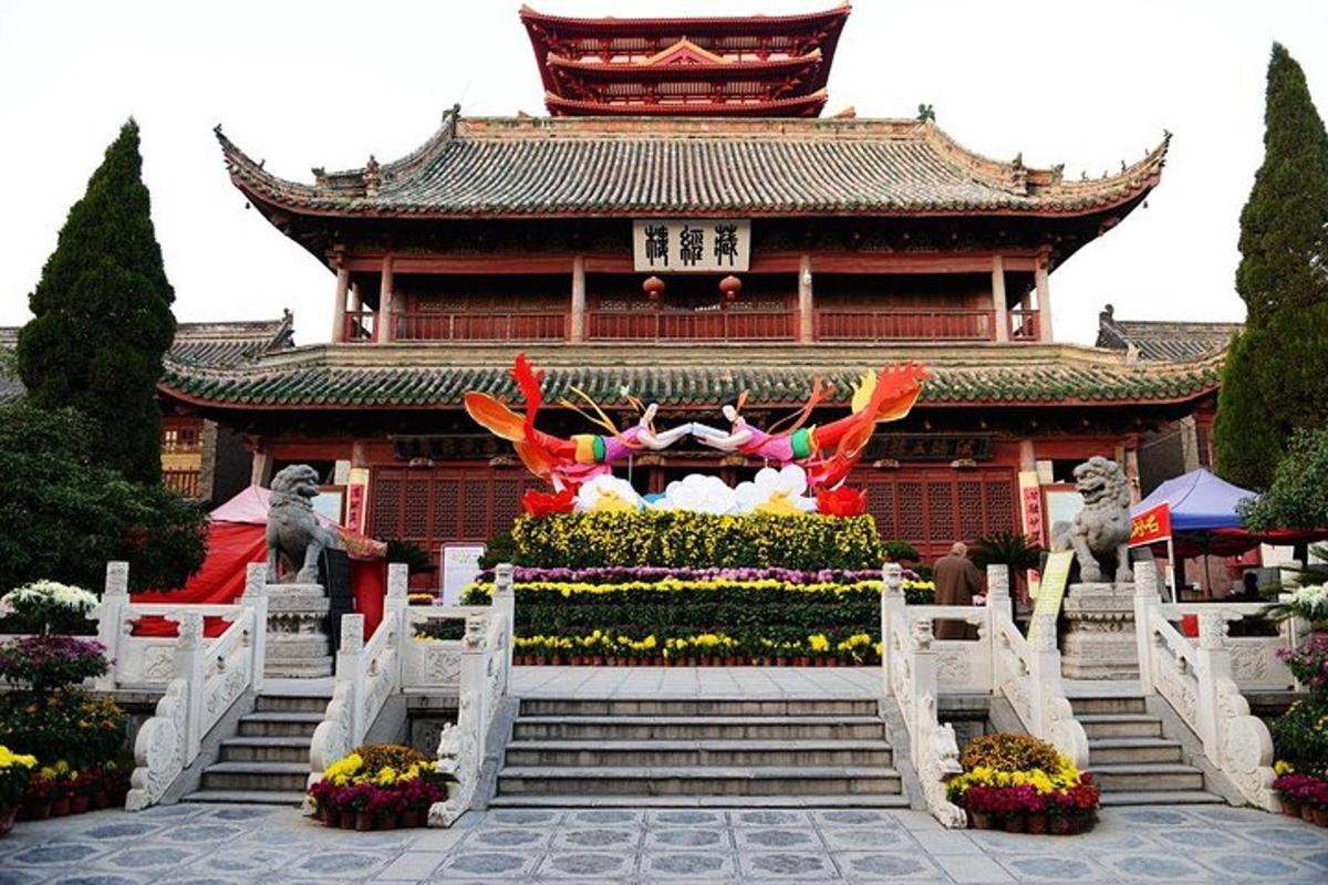 an asian building with a statue in front of it