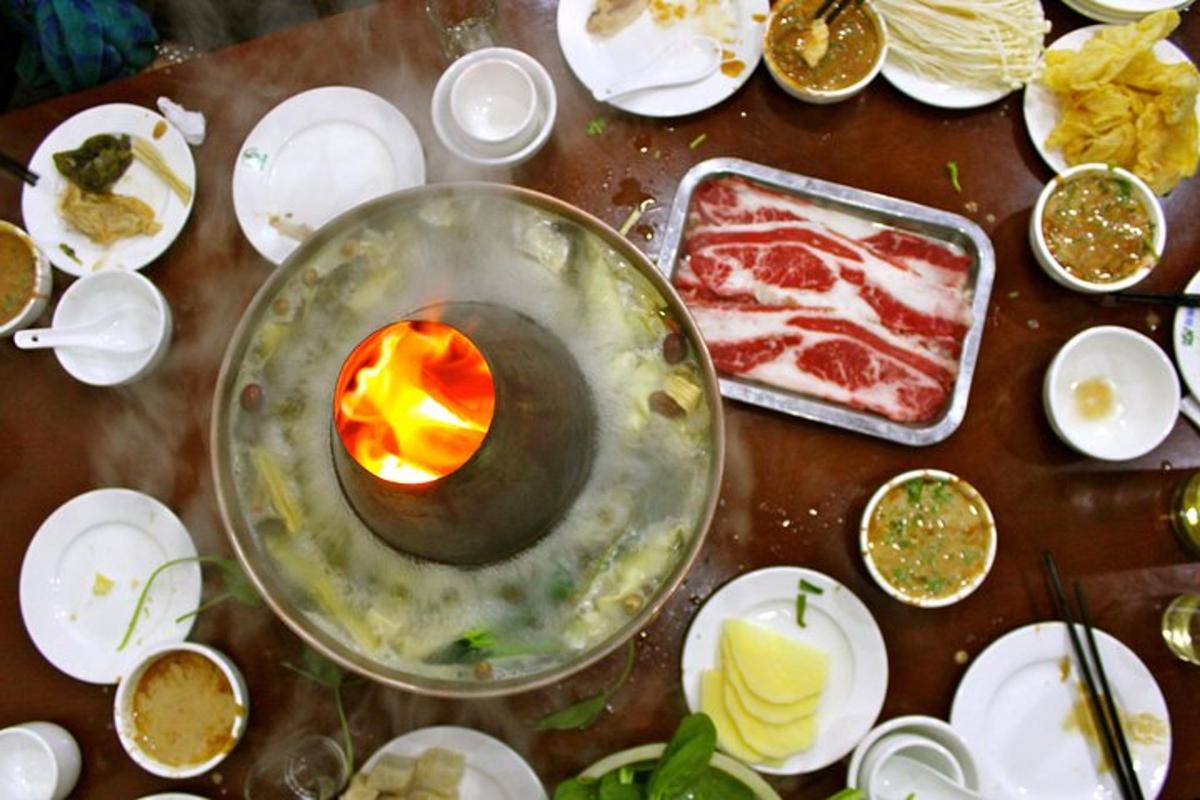 a table with a candle and plates of food