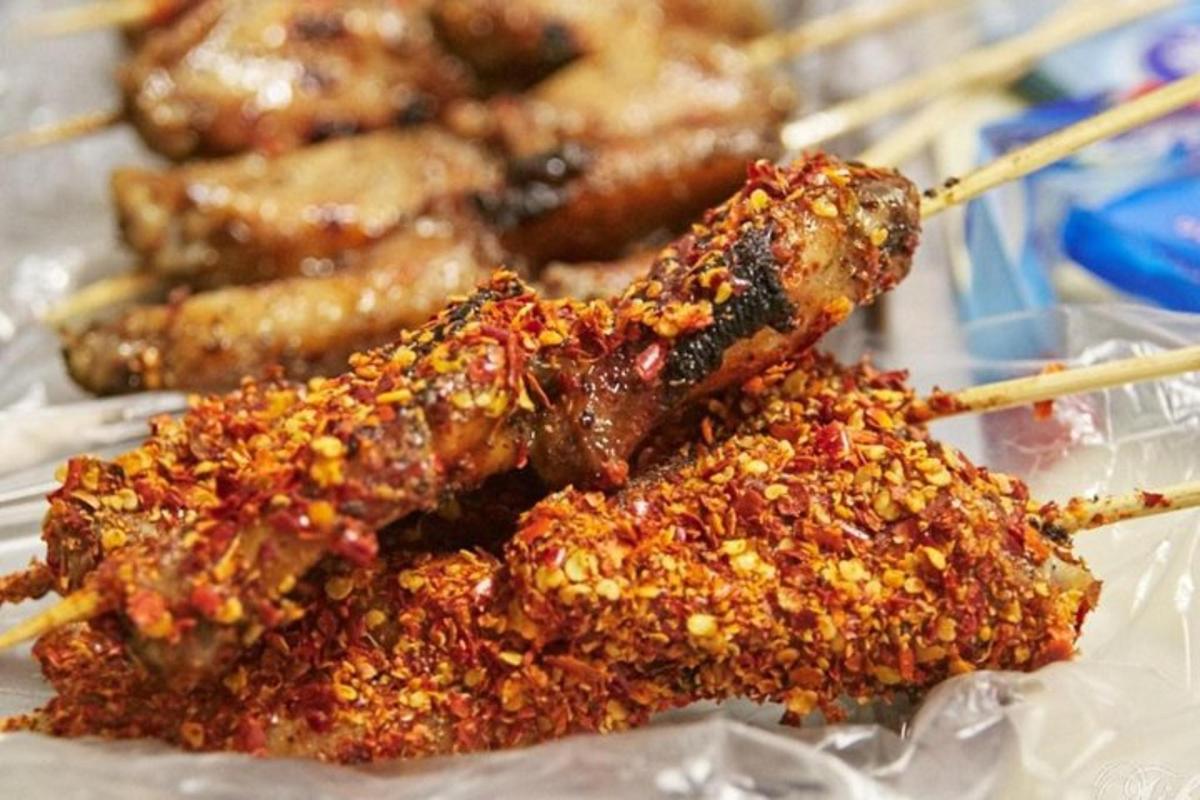 a bunch of food on a table with chop sticks