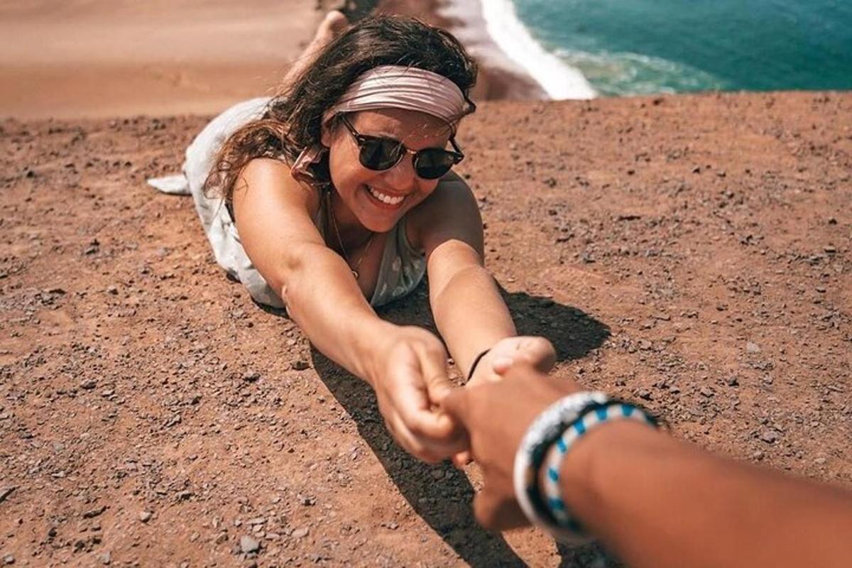 a woman laying on the ground holding a mans hand