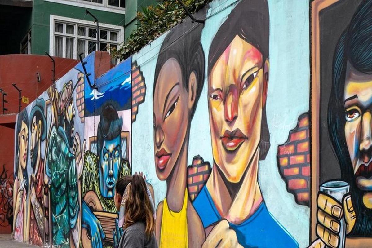 people walking in front of a mural of women