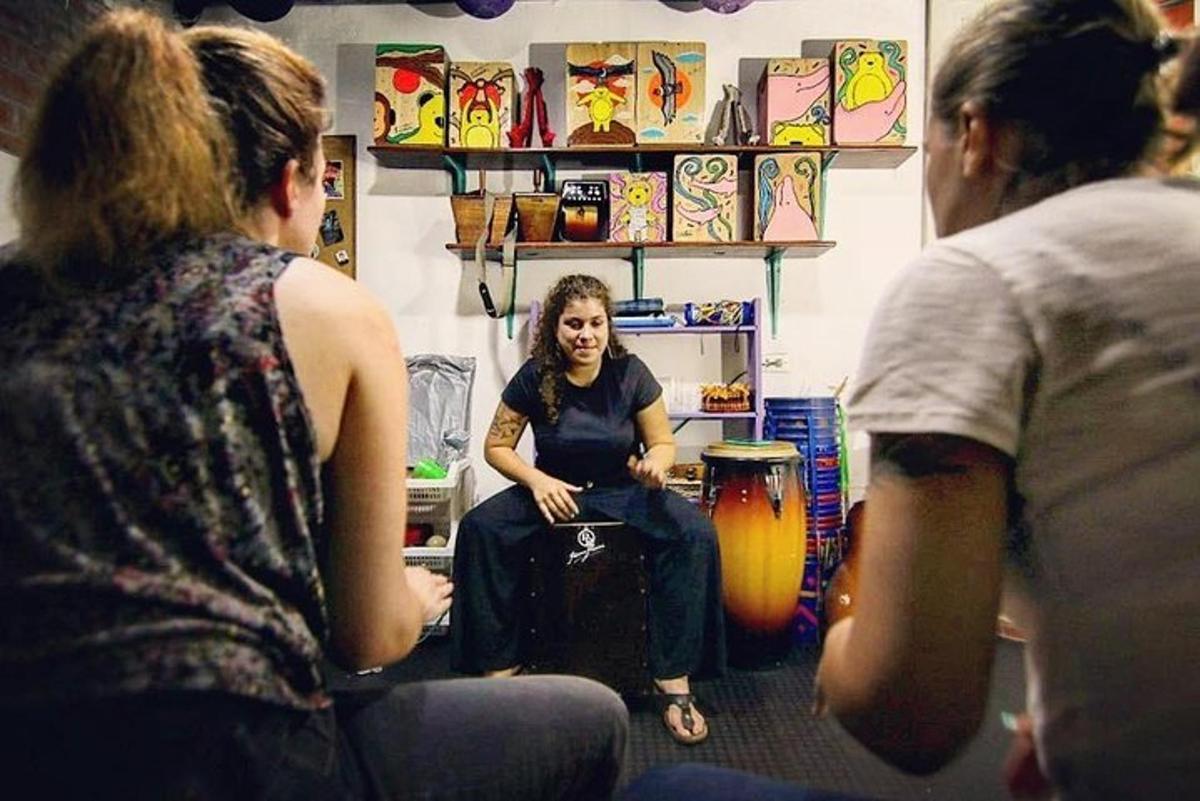 a woman sitting in a room talking to two women