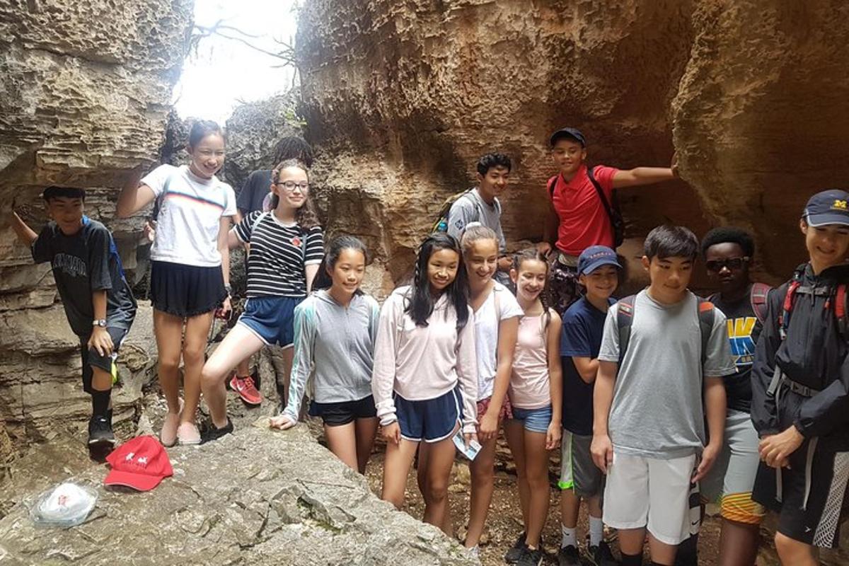 a group of people posing for a picture in a cave