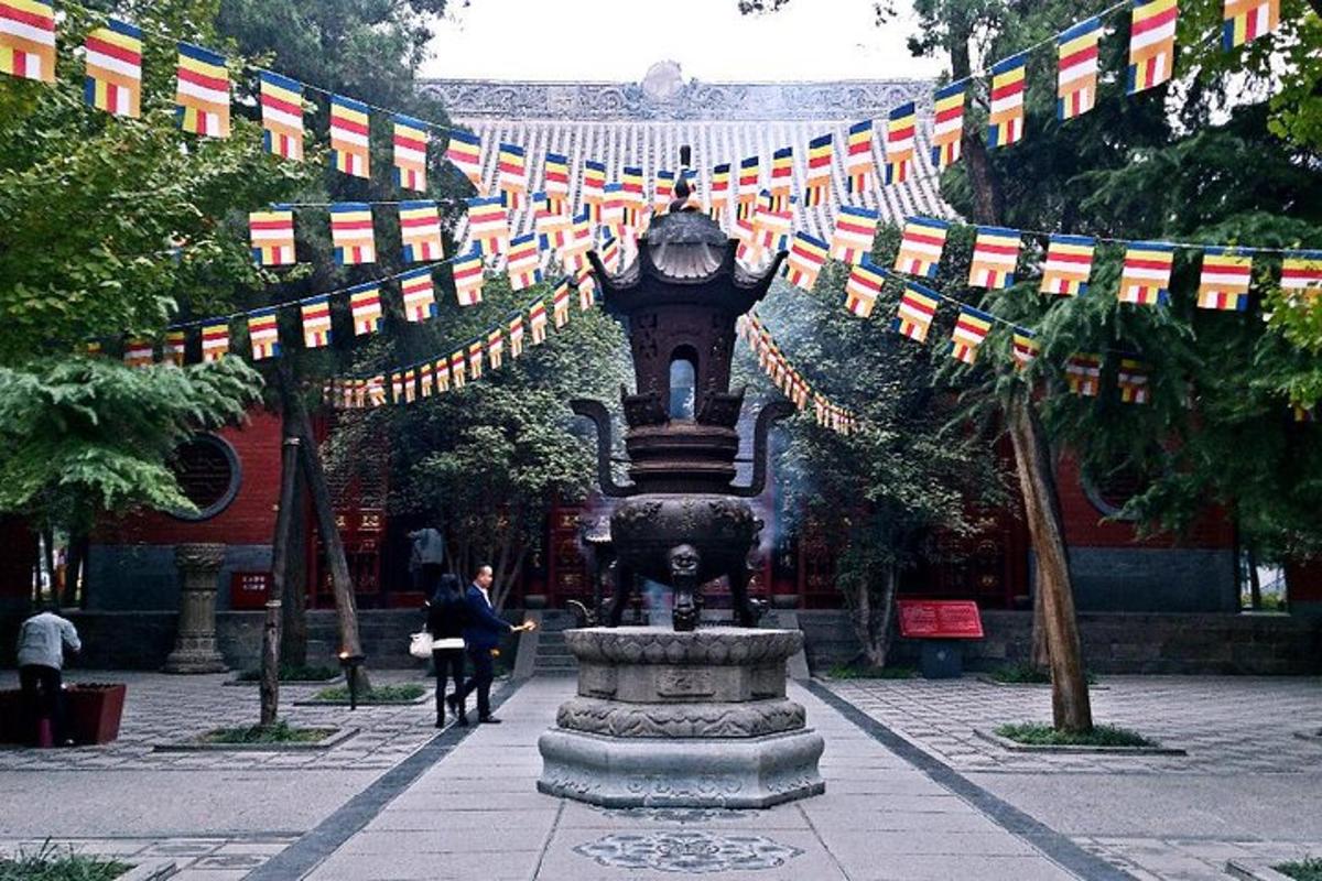 a fountain in the middle of a courtyard with flags