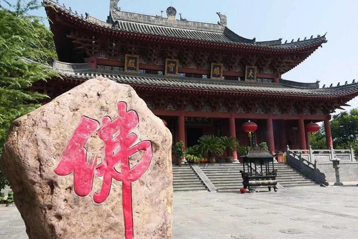 a large building with a large rock in front of it