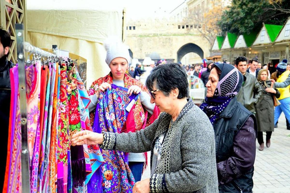 a woman looking at a display of clothing in a market