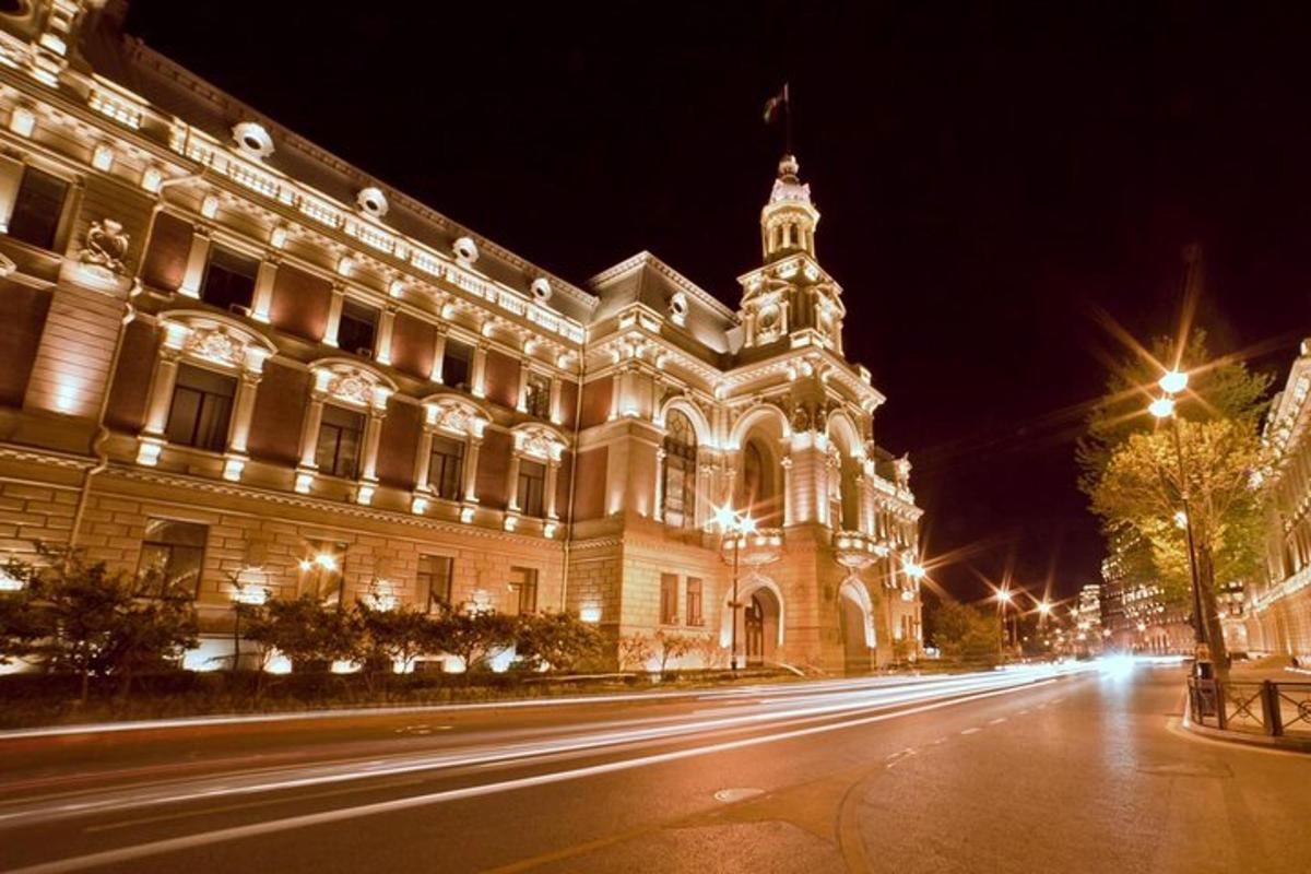 a large building with lights on a street at night