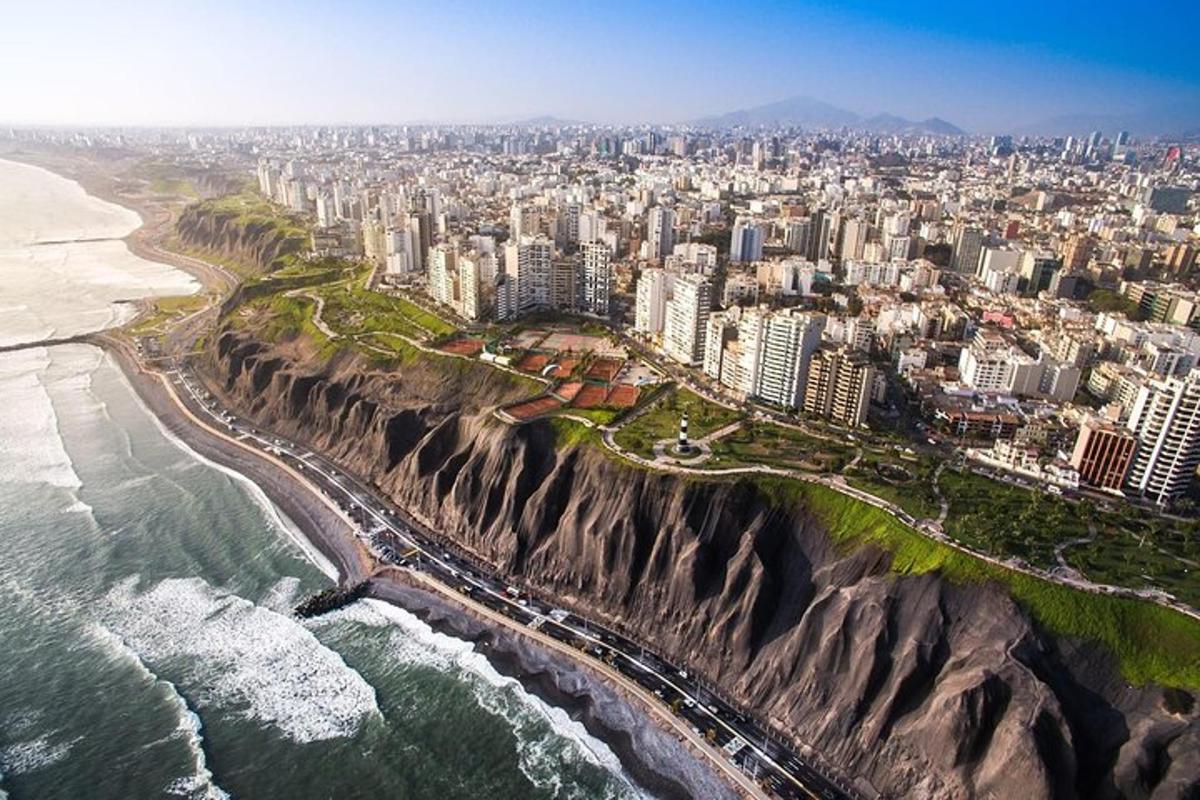an aerial view of a city next to the ocean