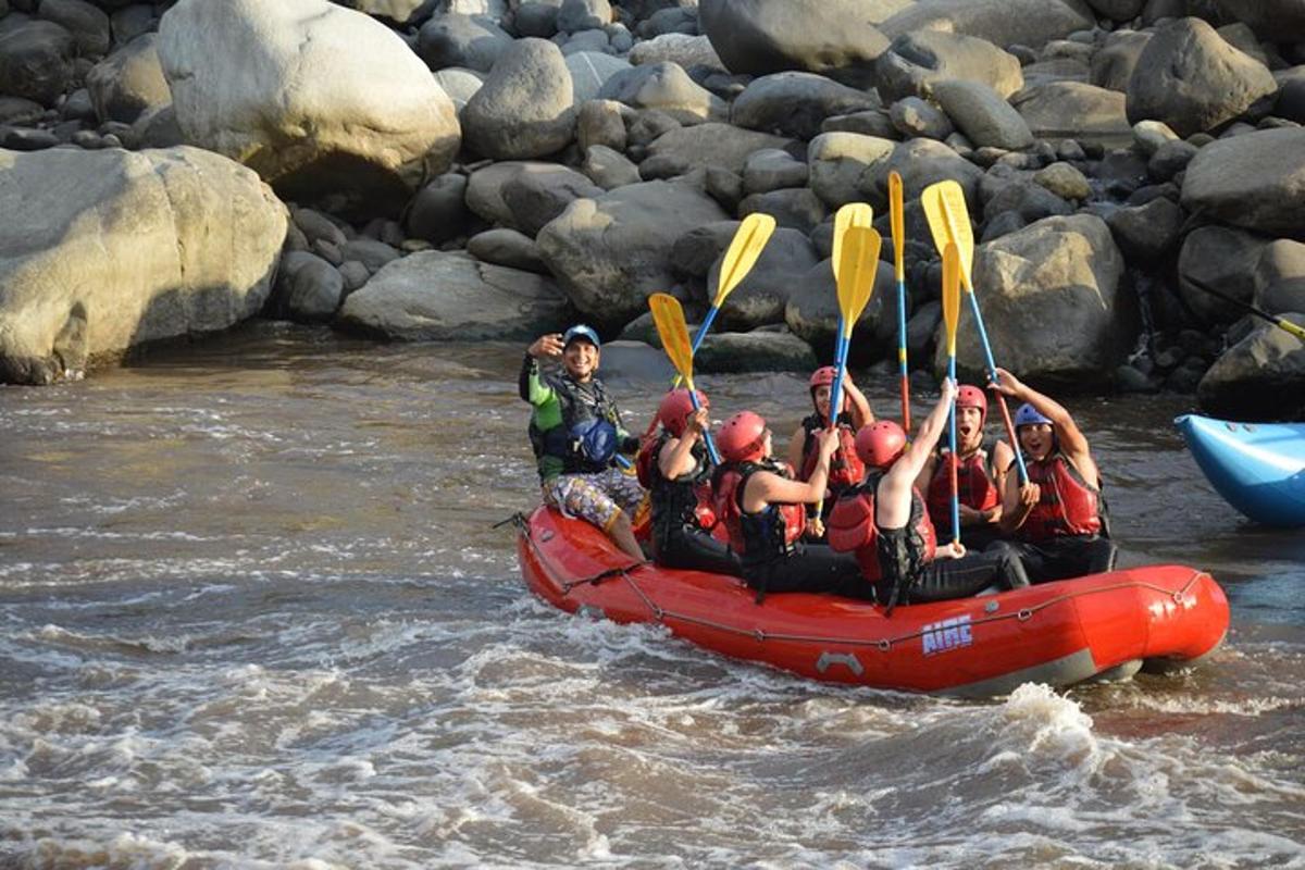 a group of people in a raft in the water