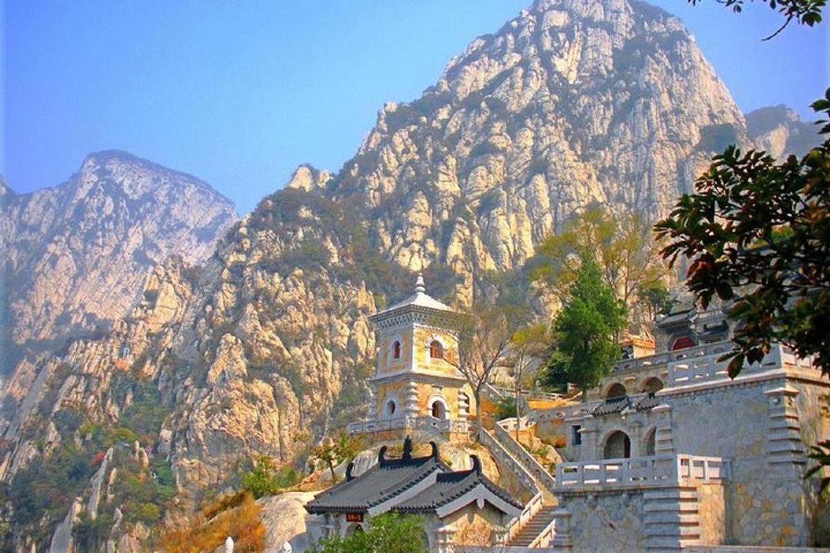 an old building in front of a mountain