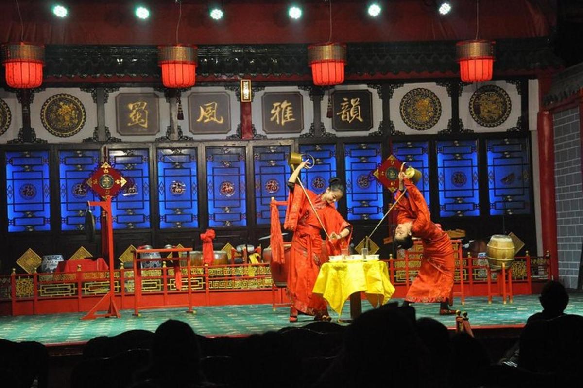two men in orange robes performing on a stage