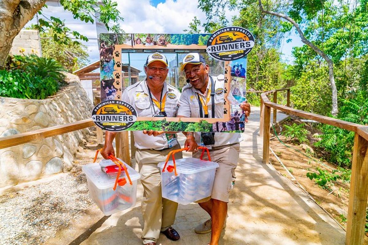 two men are holding up a sign at a zoo