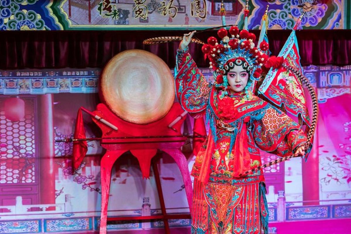 a woman in a performance with a drum in a room