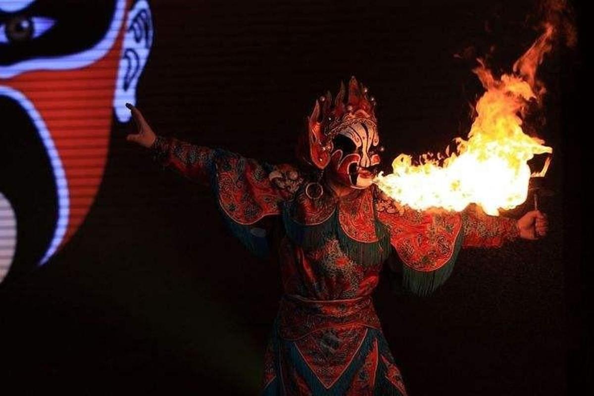 a person in a mask with a fire in his hands