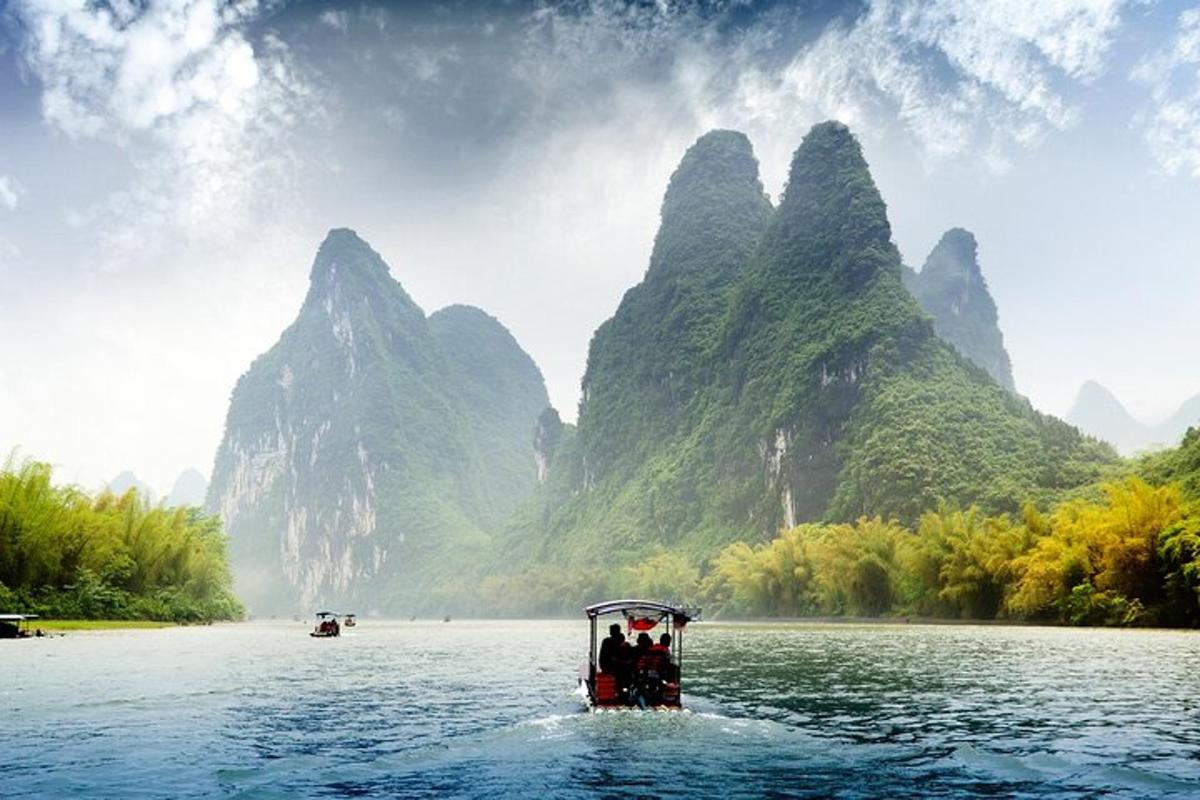 a boat on the water with mountains in the background