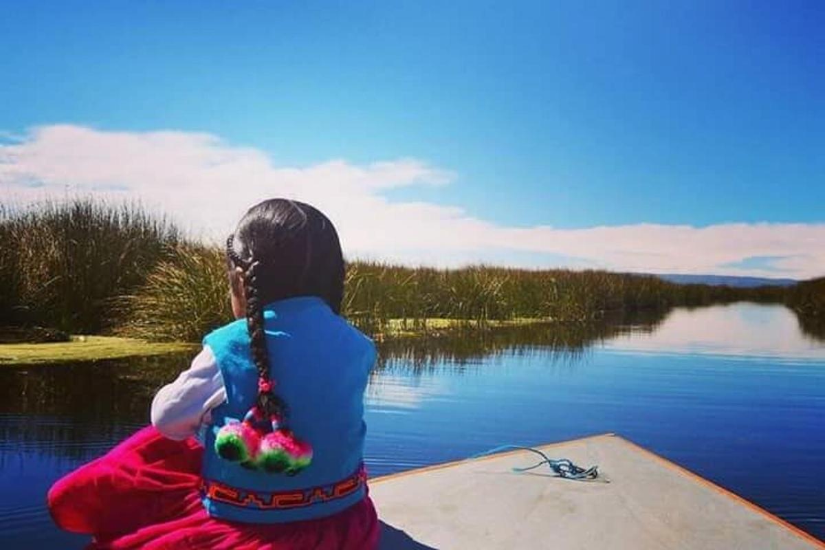 a person sitting on a boat on a body of water