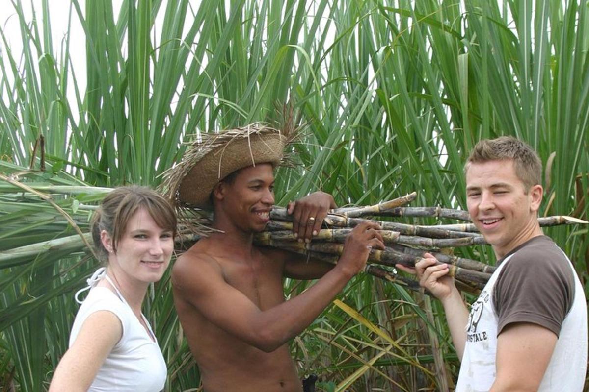 two men and a woman holding a bamboo rifle