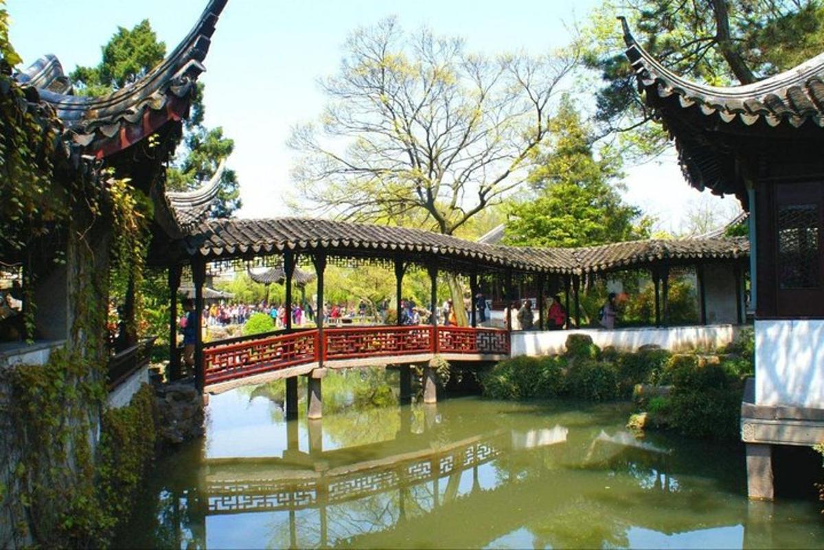 a bridge over a pond in a garden