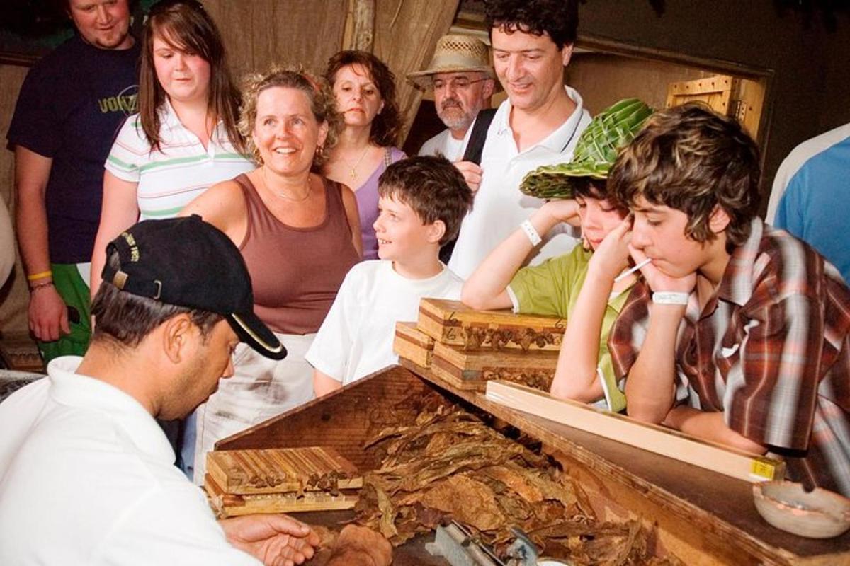 a group of people standing around a table with food