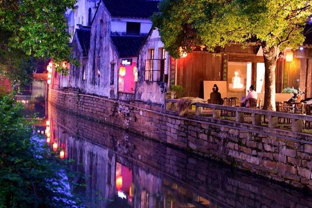 a building next to a river at night