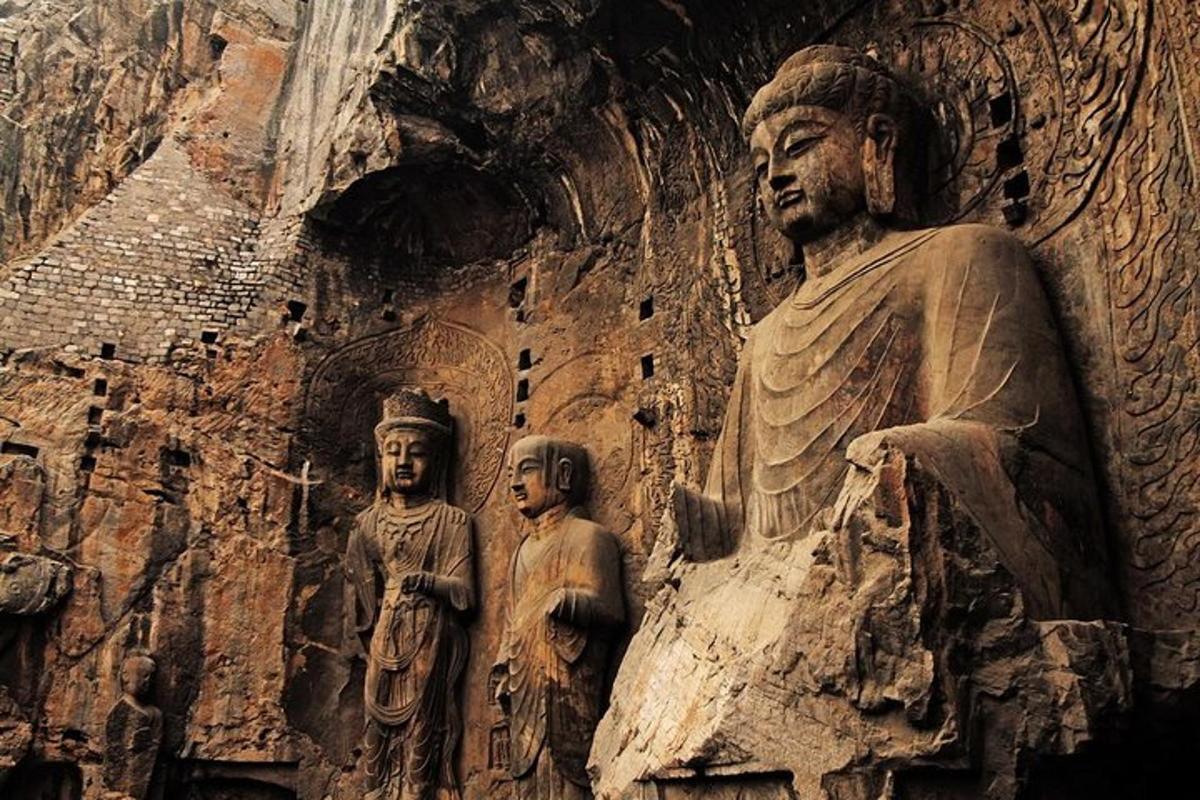 a statue of a man and two children on a wall