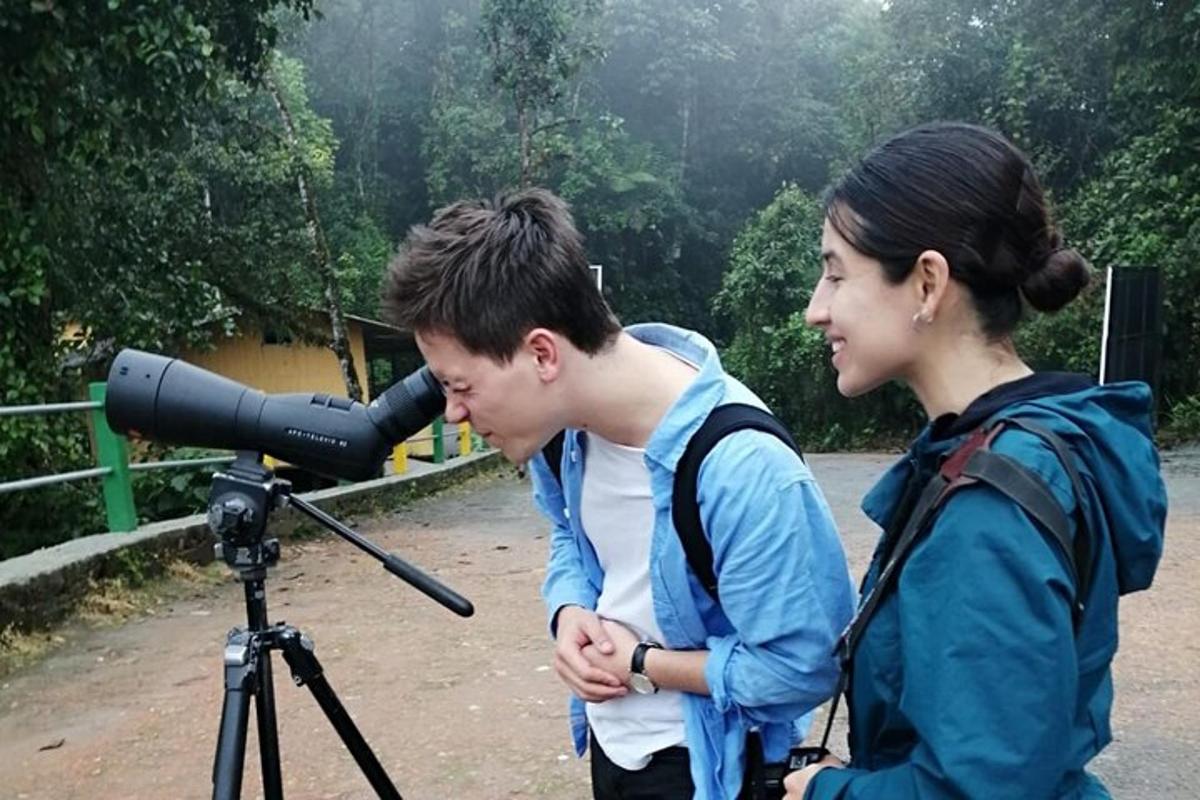 a man and a woman looking into a camera on a tripod