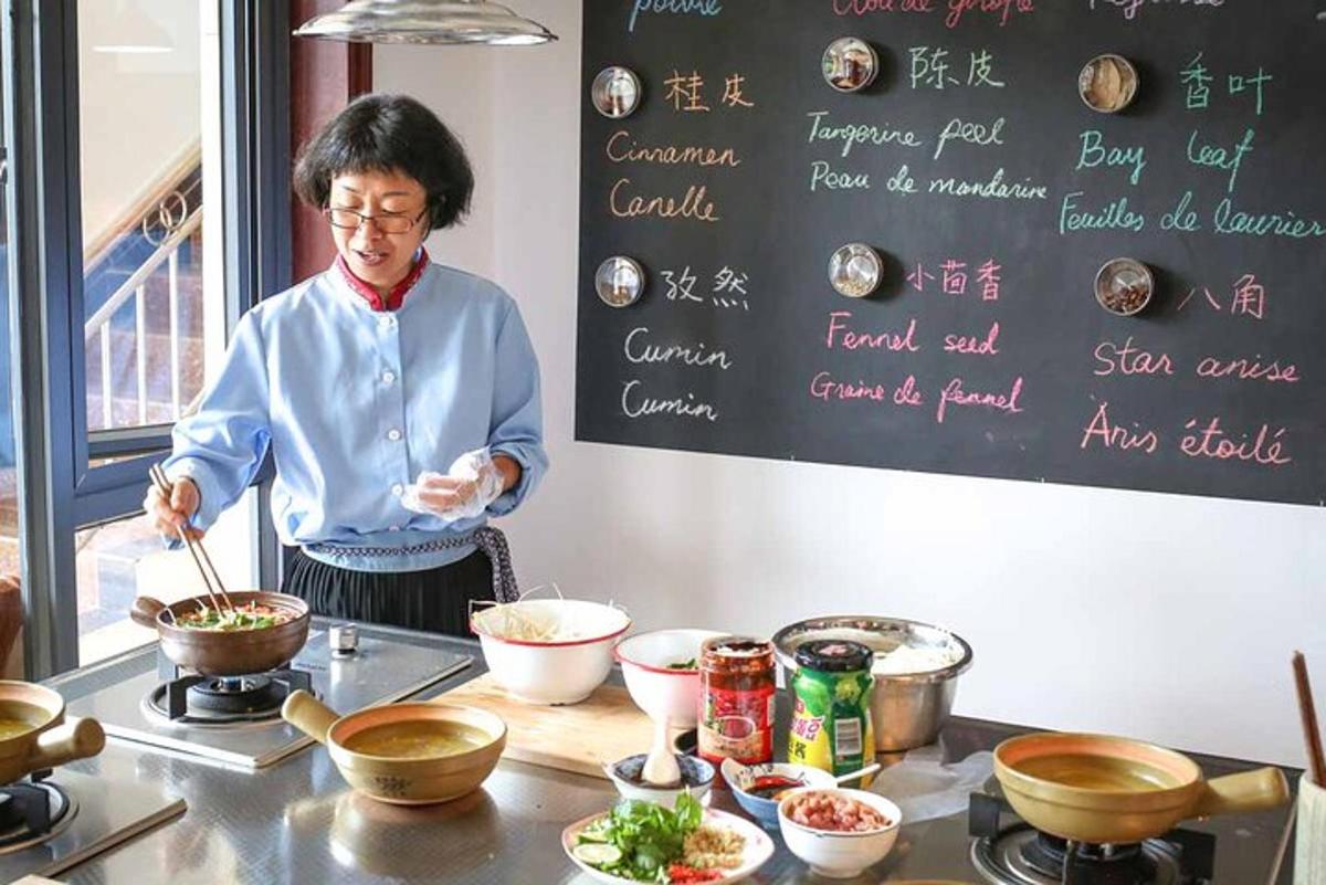 a woman standing in a kitchen preparing food