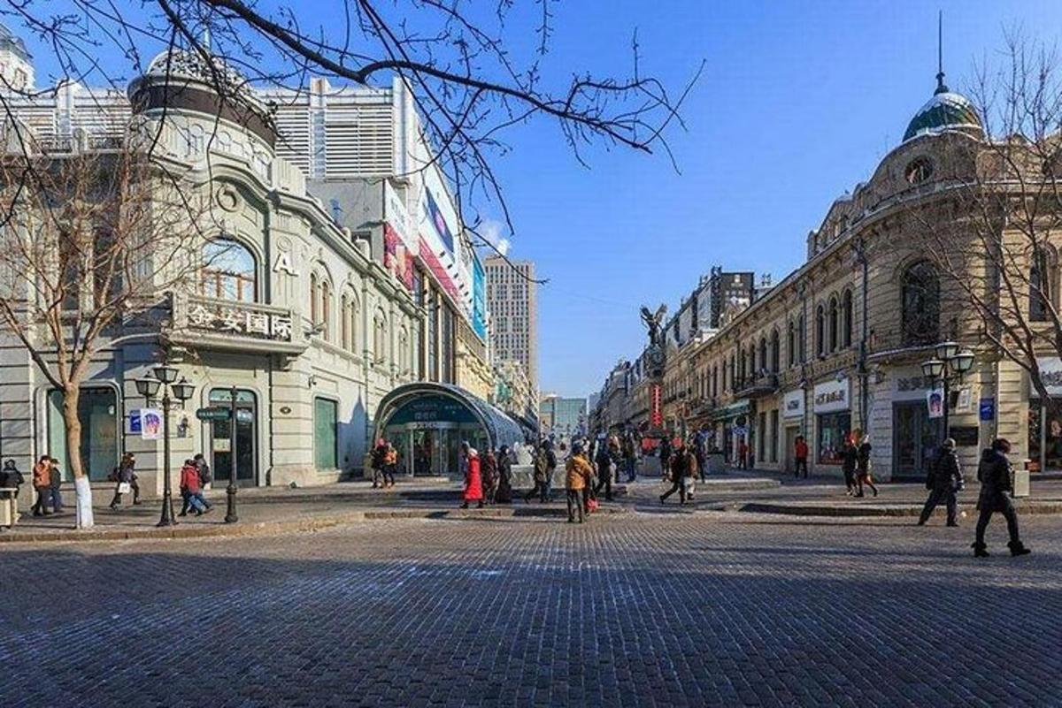 a group of people walking on a city street