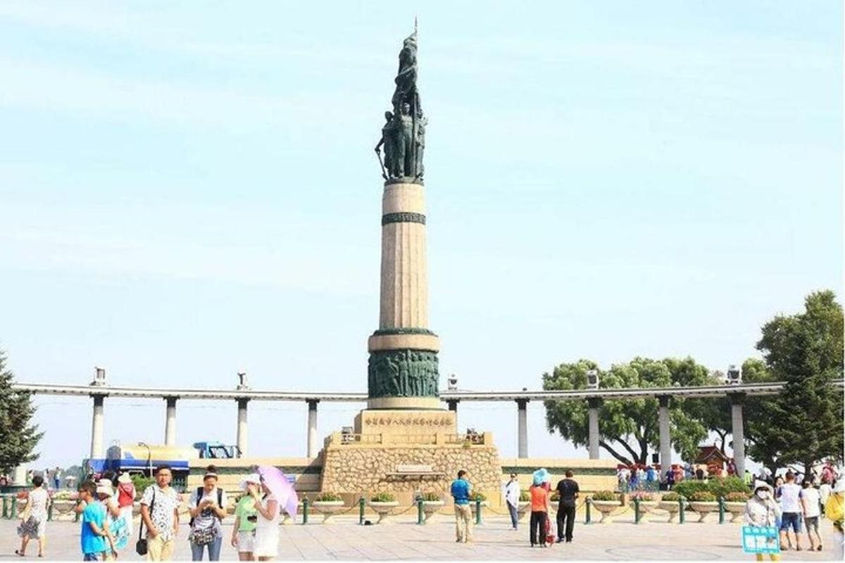 a group of people standing around a statue