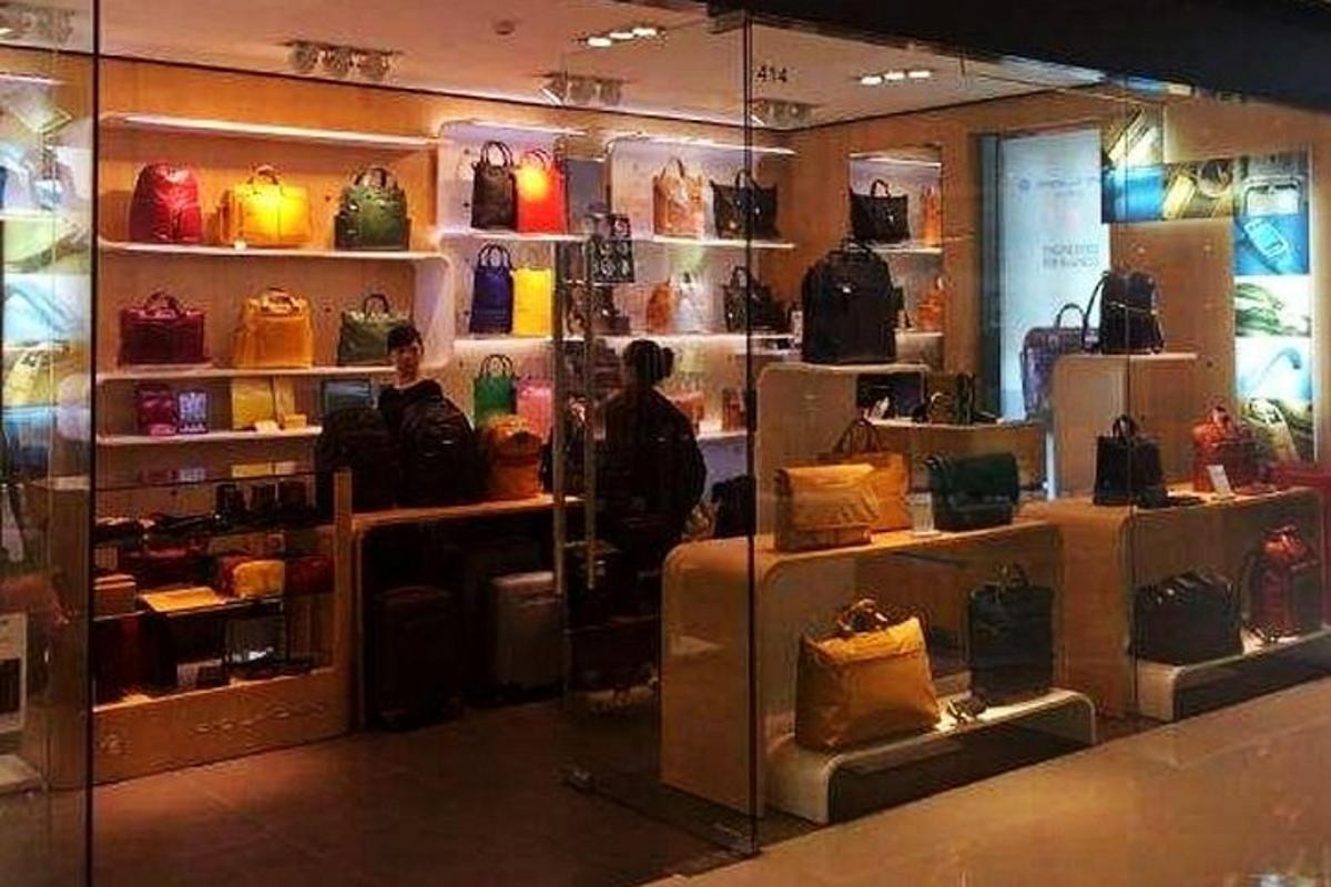 a group of people standing in a store with bags