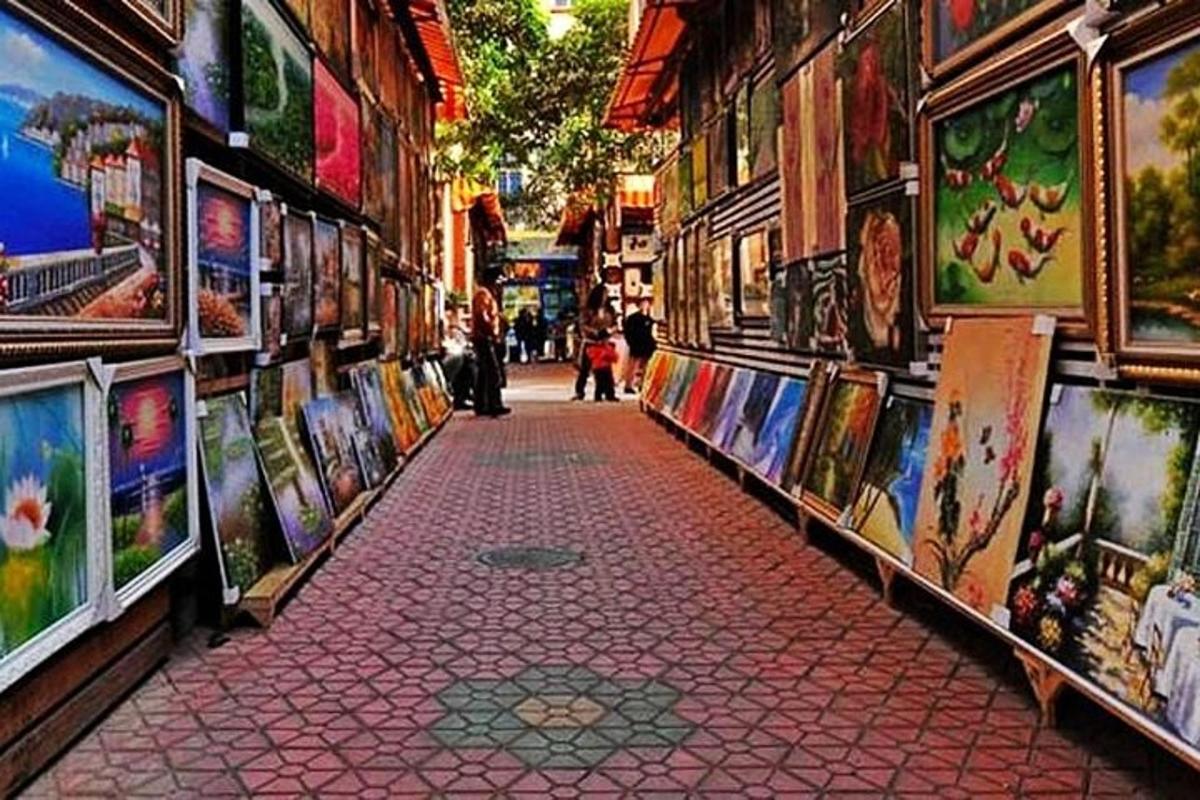 a street with paintings on the side of a building