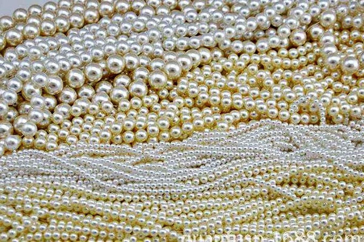 a close up of a beaded fabric with pearl beads