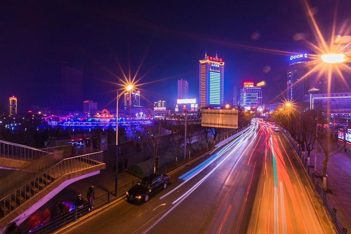 a city at night with street lights and buildings