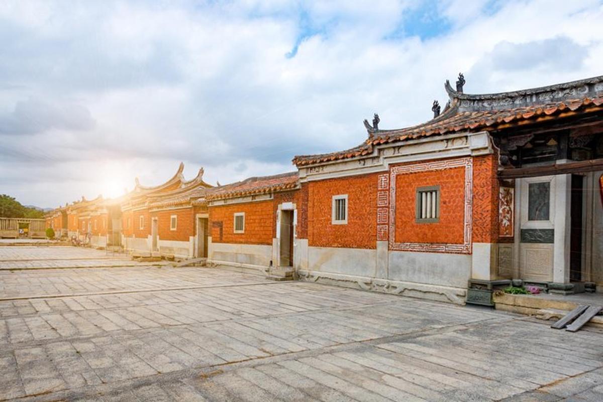 a row of brick buildings with the sun in the background