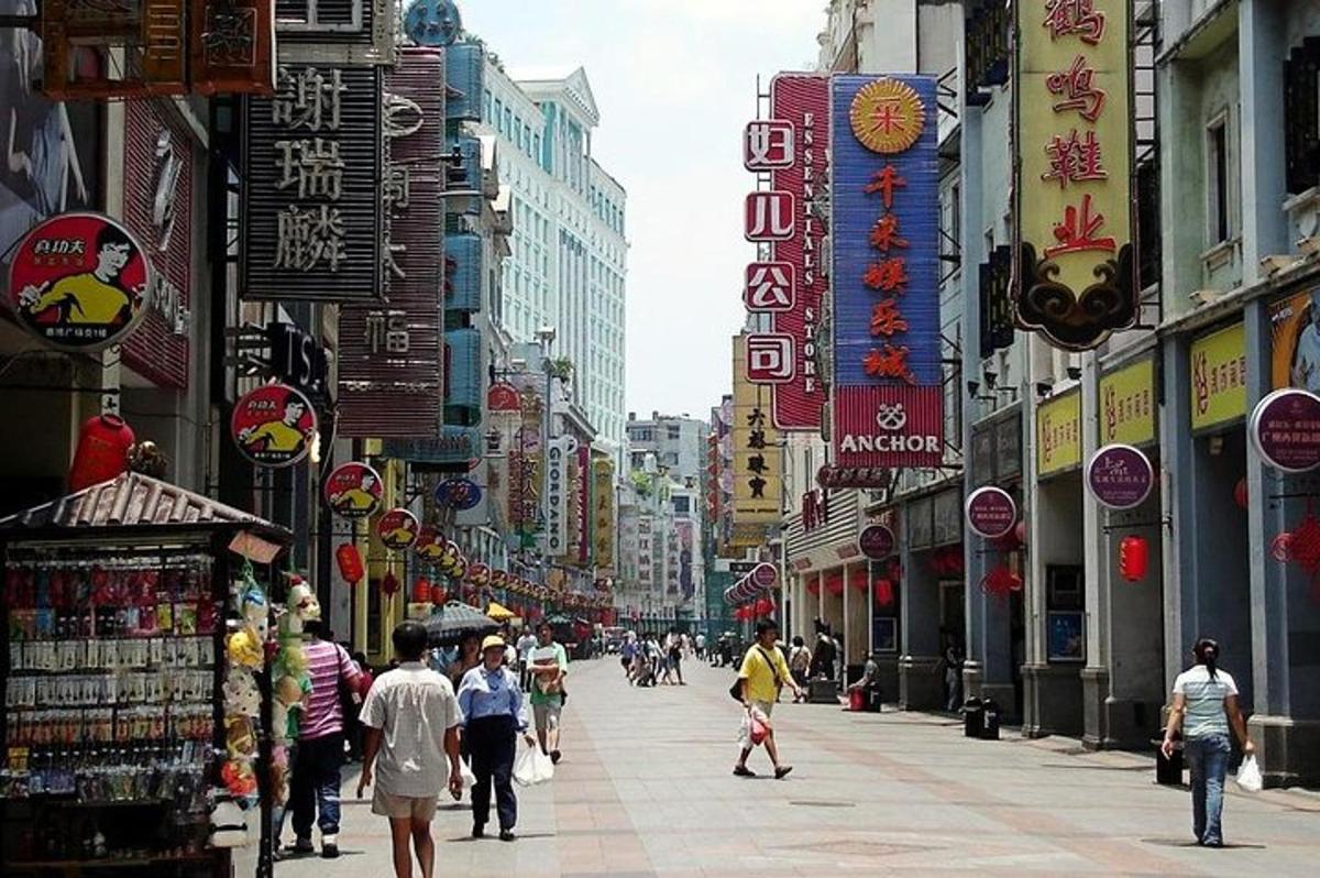 a busy city street with people walking down the street